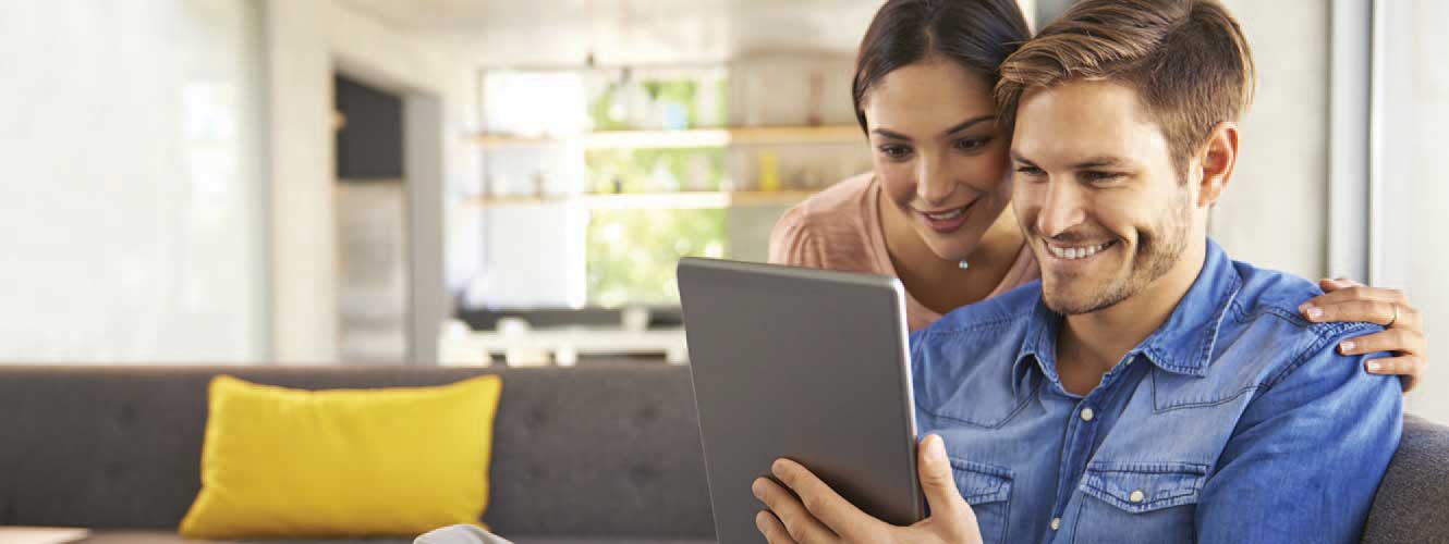 Image of couple looking at a mobile tablet together